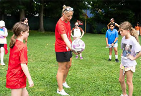 Cassandra running a soccer game with Douglass.